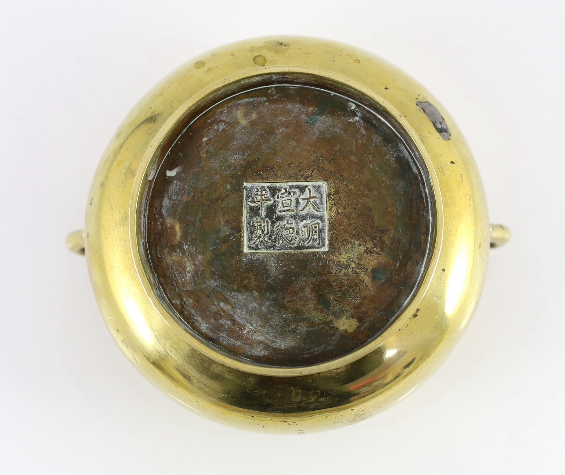 A Chinese polished bronze censer, gui, Xuande six character mark, 18th/19th century, 19cm wide, dented, solder repair